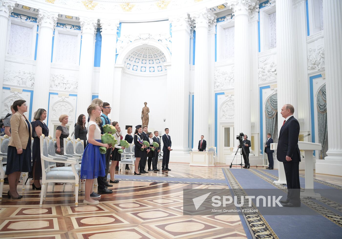 Russian President Vladimir Putin presents passports to young Russian citizens on Russia Day