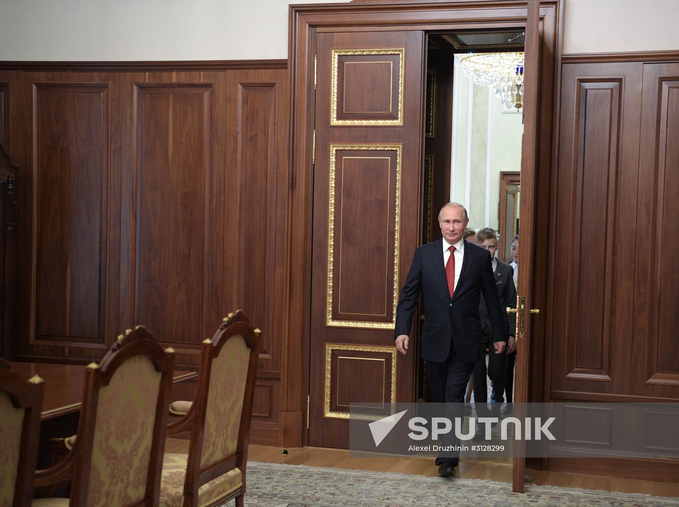 Russian President Vladimir Putin presents passports to young Russian citizens on Russia Day