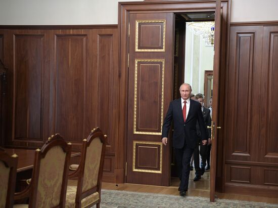 Russian President Vladimir Putin presents passports to young Russian citizens on Russia Day