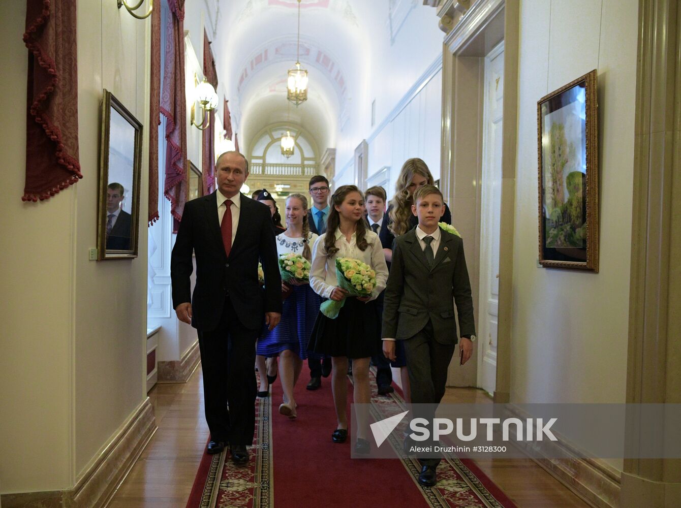 Russian President Vladimir Putin presents passports to young Russian citizens on Russia Day