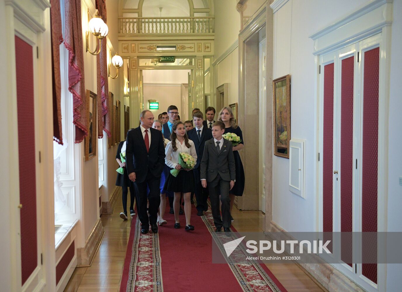 Russian President Vladimir Putin presents passports to young Russian citizens on Russia Day