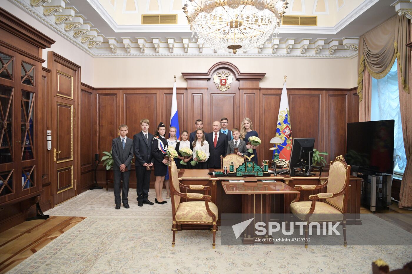 Russian President Vladimir Putin presents passports to young Russian citizens on Russia Day