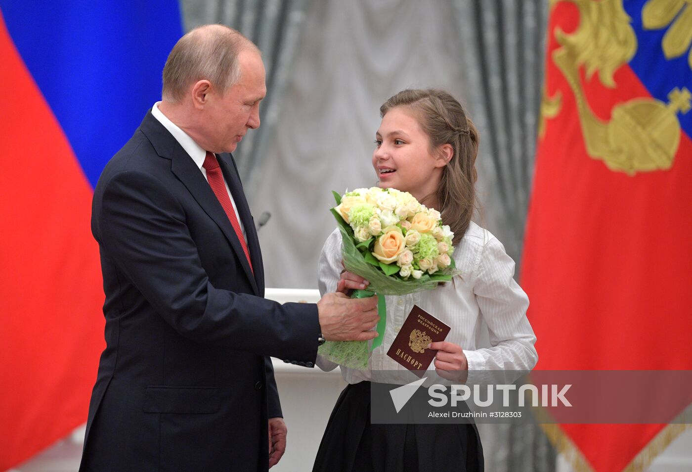 Russian President Vladimir Putin presents passports to young Russian citizens on Russia Day
