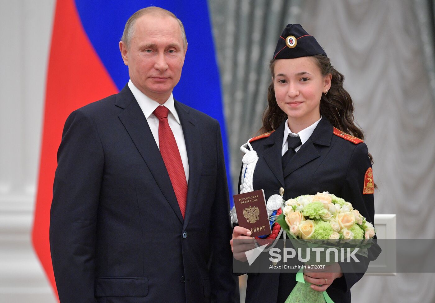 Russian President Vladimir Putin presents passports to young Russian citizens on Russia Day