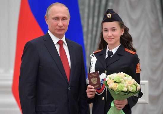 Russian President Vladimir Putin presents passports to young Russian citizens on Russia Day