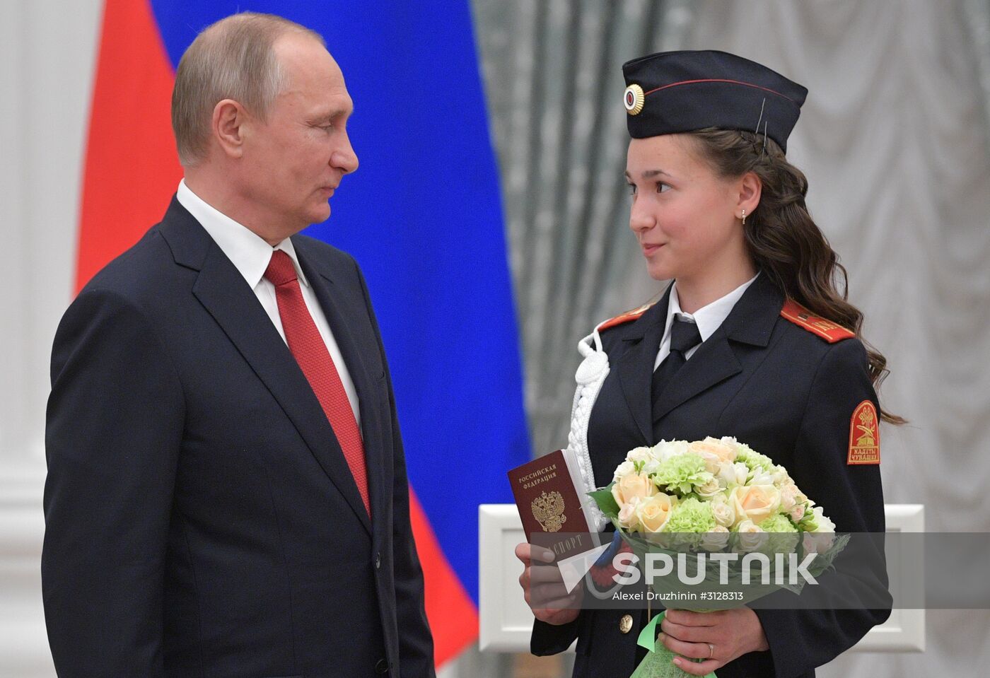 Russian President Vladimir Putin presents passports to young Russian citizens on Russia Day