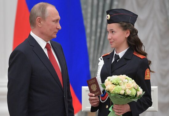 Russian President Vladimir Putin presents passports to young Russian citizens on Russia Day