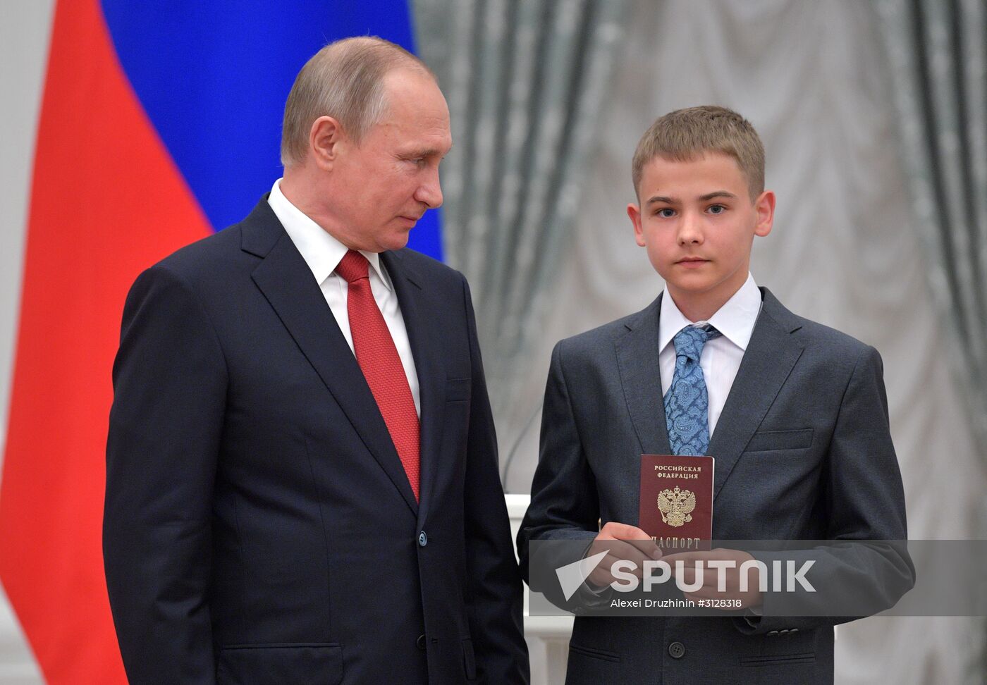 Russian President Vladimir Putin presents passports to young Russian citizens on Russia Day