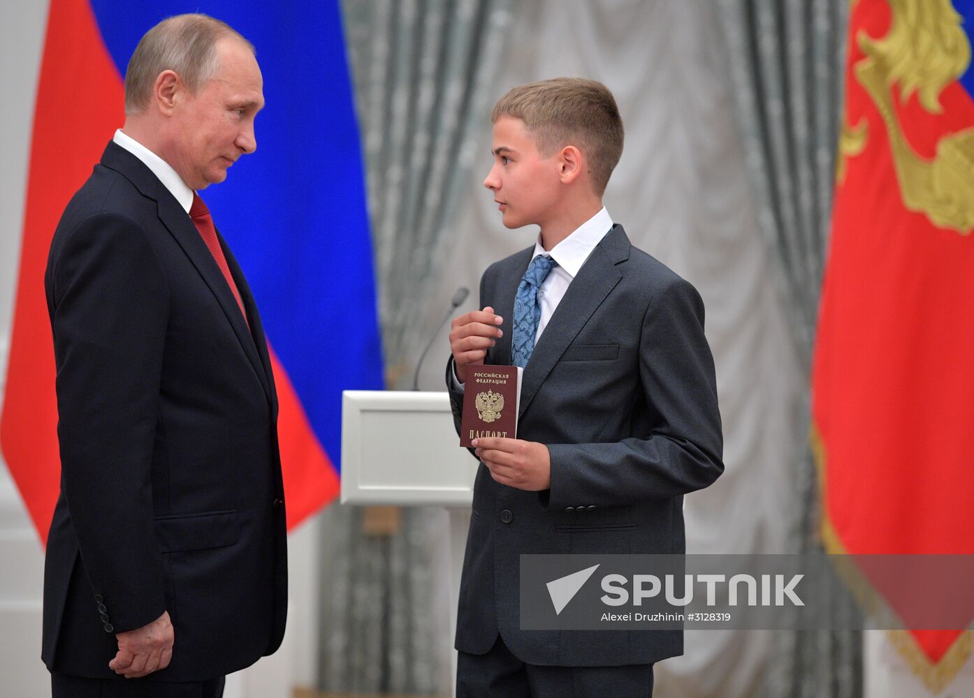 Russian President Vladimir Putin presents passports to young Russian citizens on Russia Day