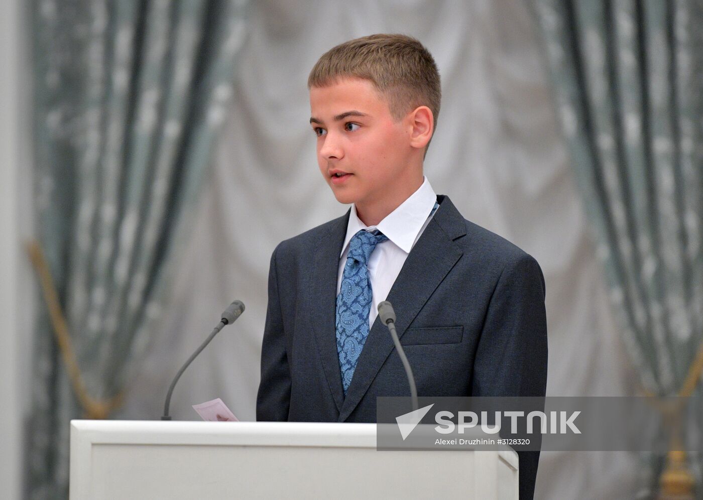 Russian President Vladimir Putin presents passports to young Russian citizens on Russia Day