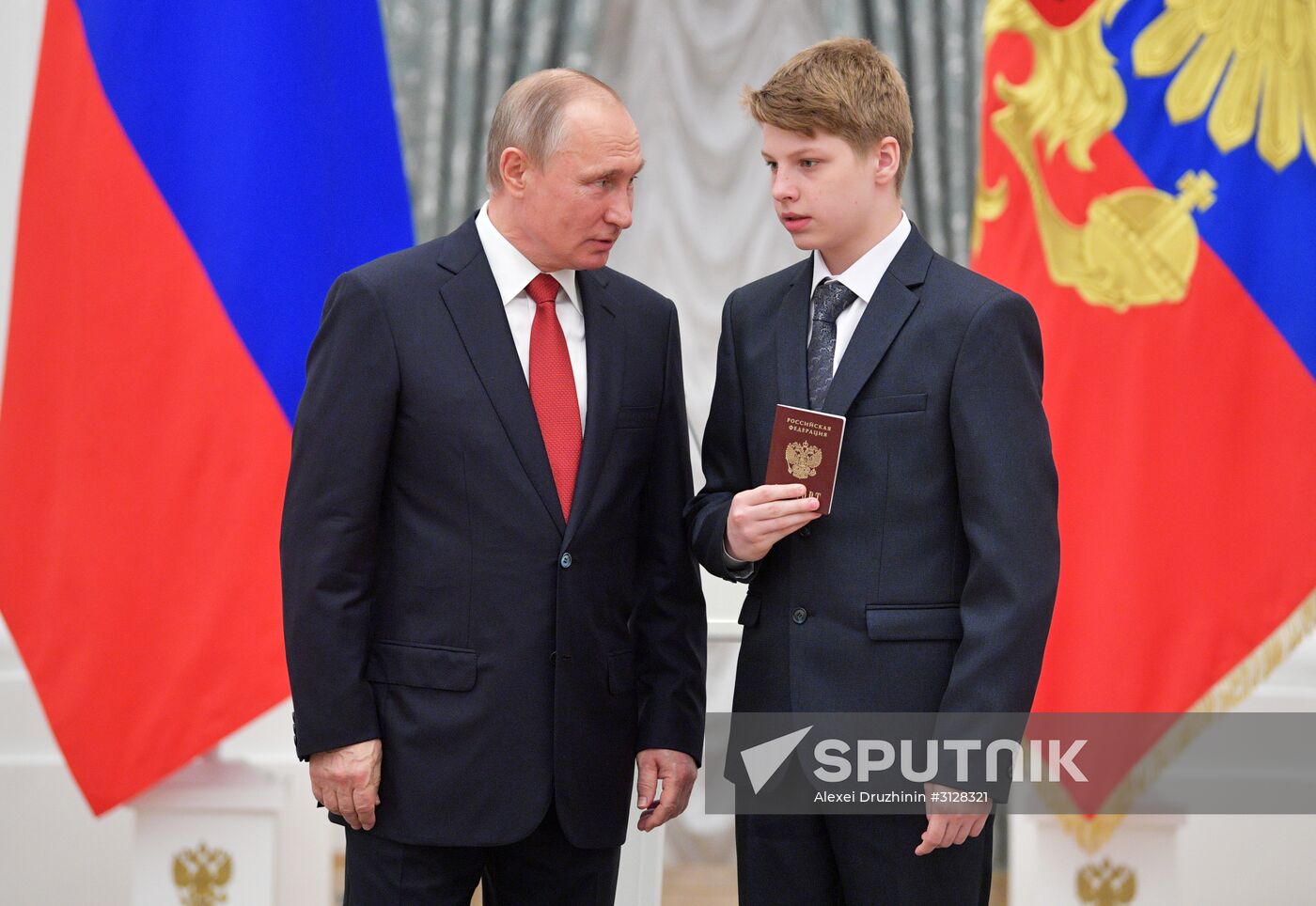 Russian President Vladimir Putin presents passports to young Russian citizens on Russia Day