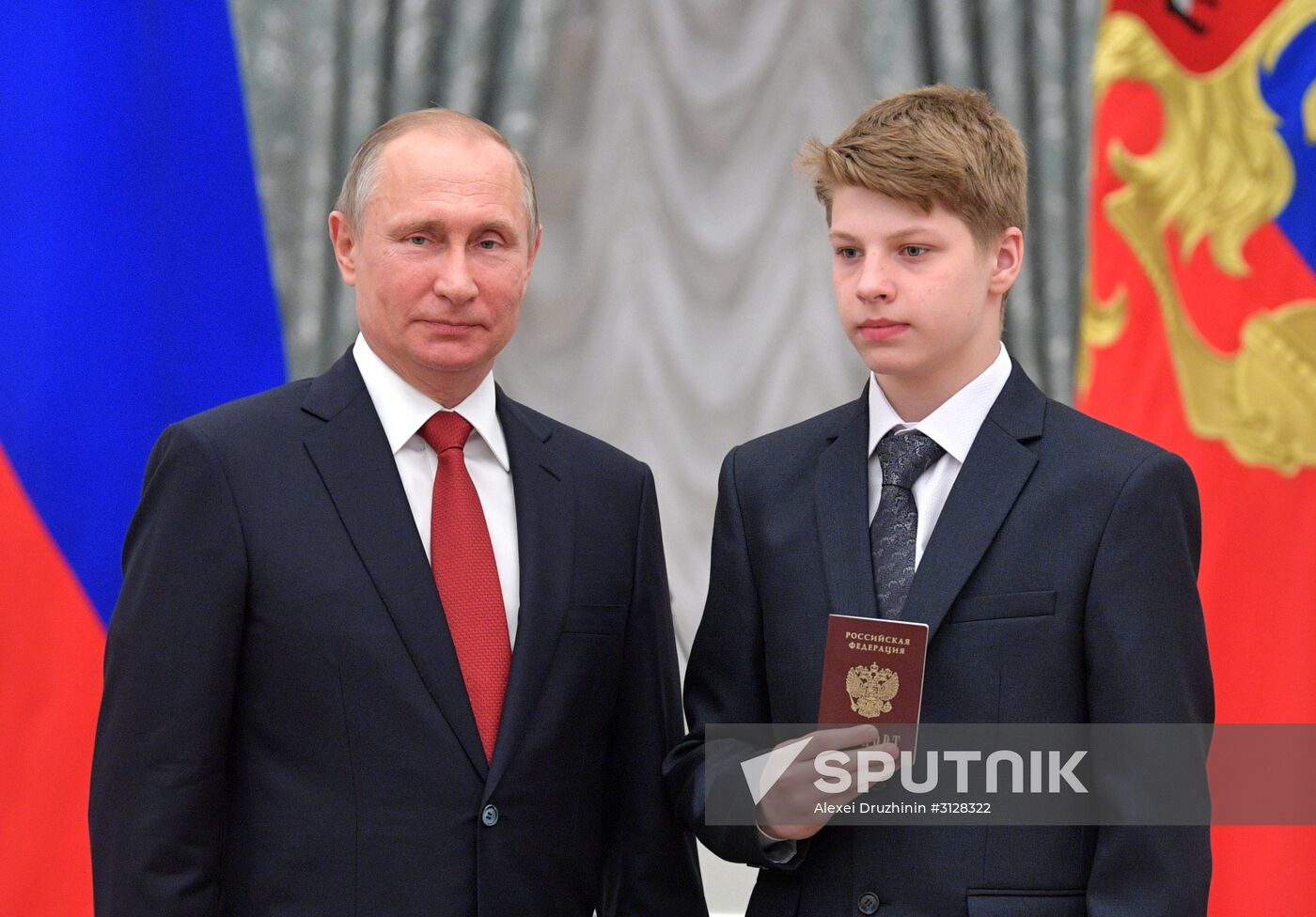 Russian President Vladimir Putin presents passports to young Russian citizens on Russia Day