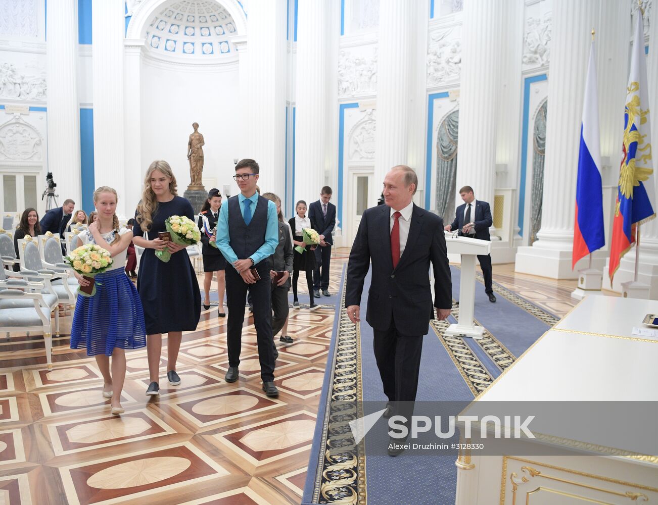 Russian President Vladimir Putin presents passports to young Russian citizens on Russia Day