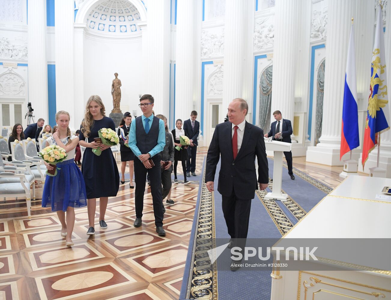 Russian President Vladimir Putin presents passports to young Russian citizens on Russia Day