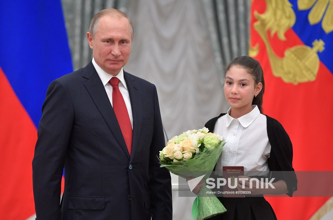 Russian President Vladimir Putin presents passports to young Russian citizens on Russia Day