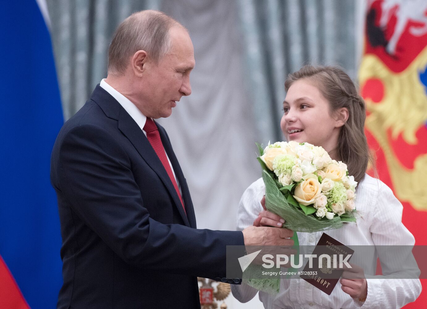 Russian President Vladimir Putin presents passports to young Russian citizens on Russia Day