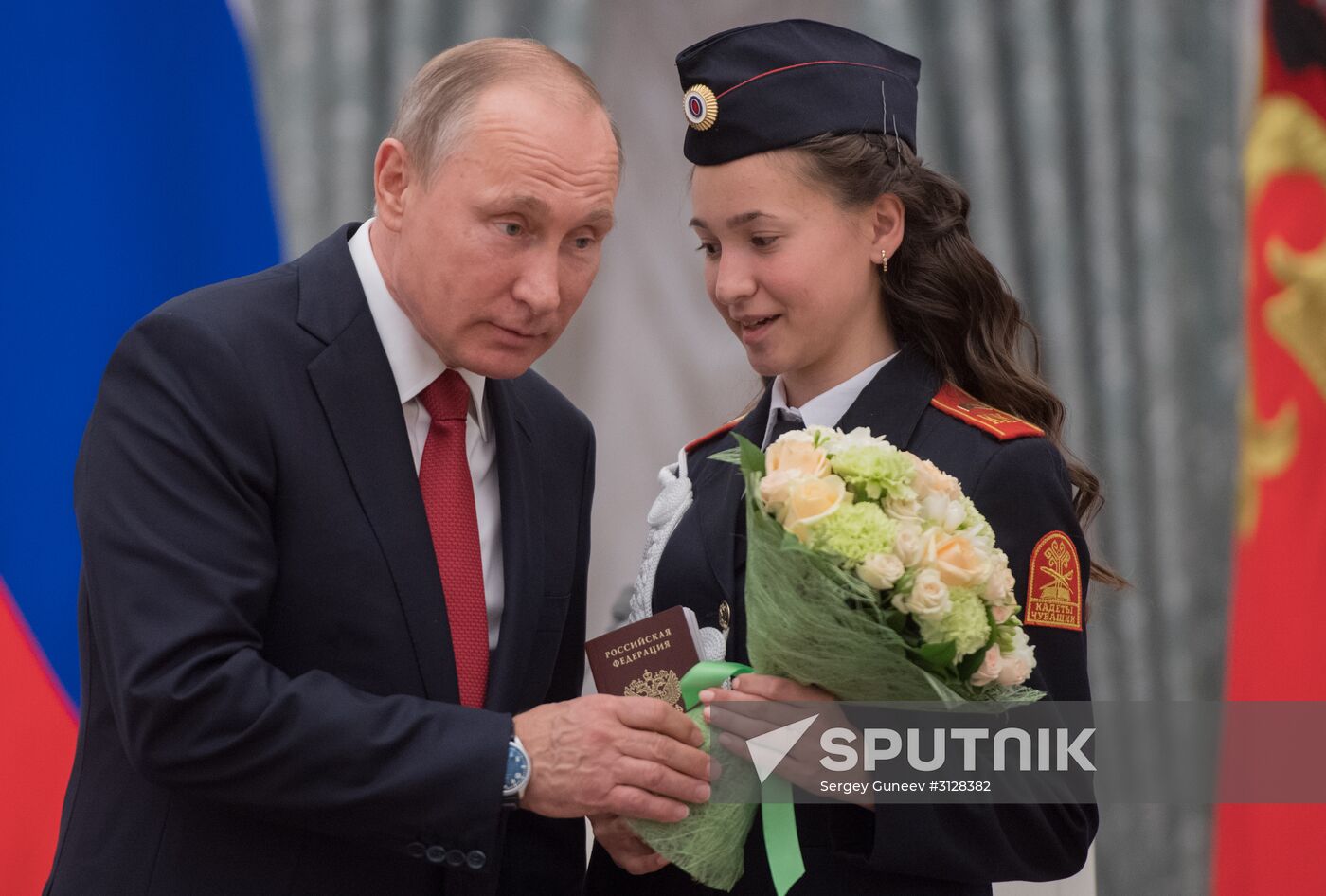 Russian President Vladimir Putin presents passports to young Russian citizens on Russia Day