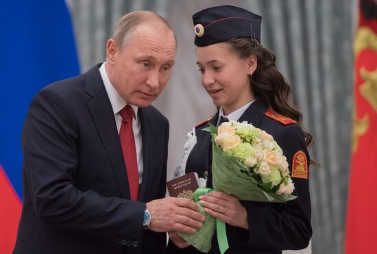 Russian President Vladimir Putin presents passports to young Russian citizens on Russia Day