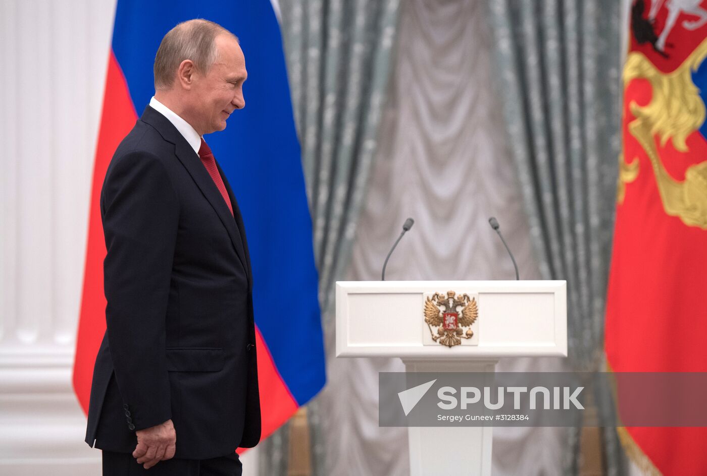 Russian President Vladimir Putin presents passports to young Russian citizens on Russia Day