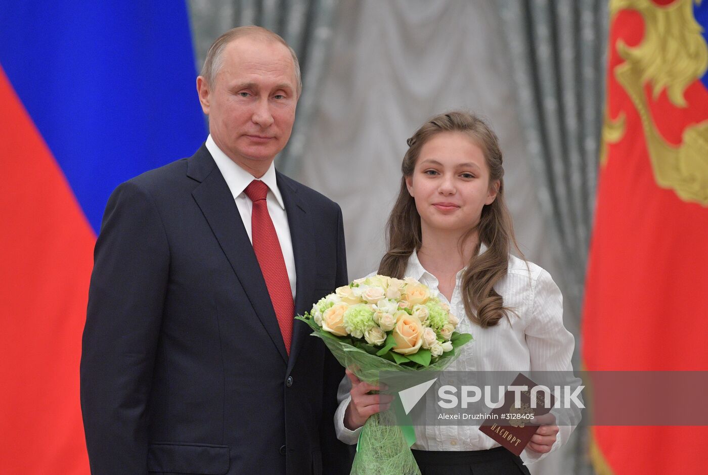 Russian President Vladimir Putin presents passports to young Russian citizens on Russia Day