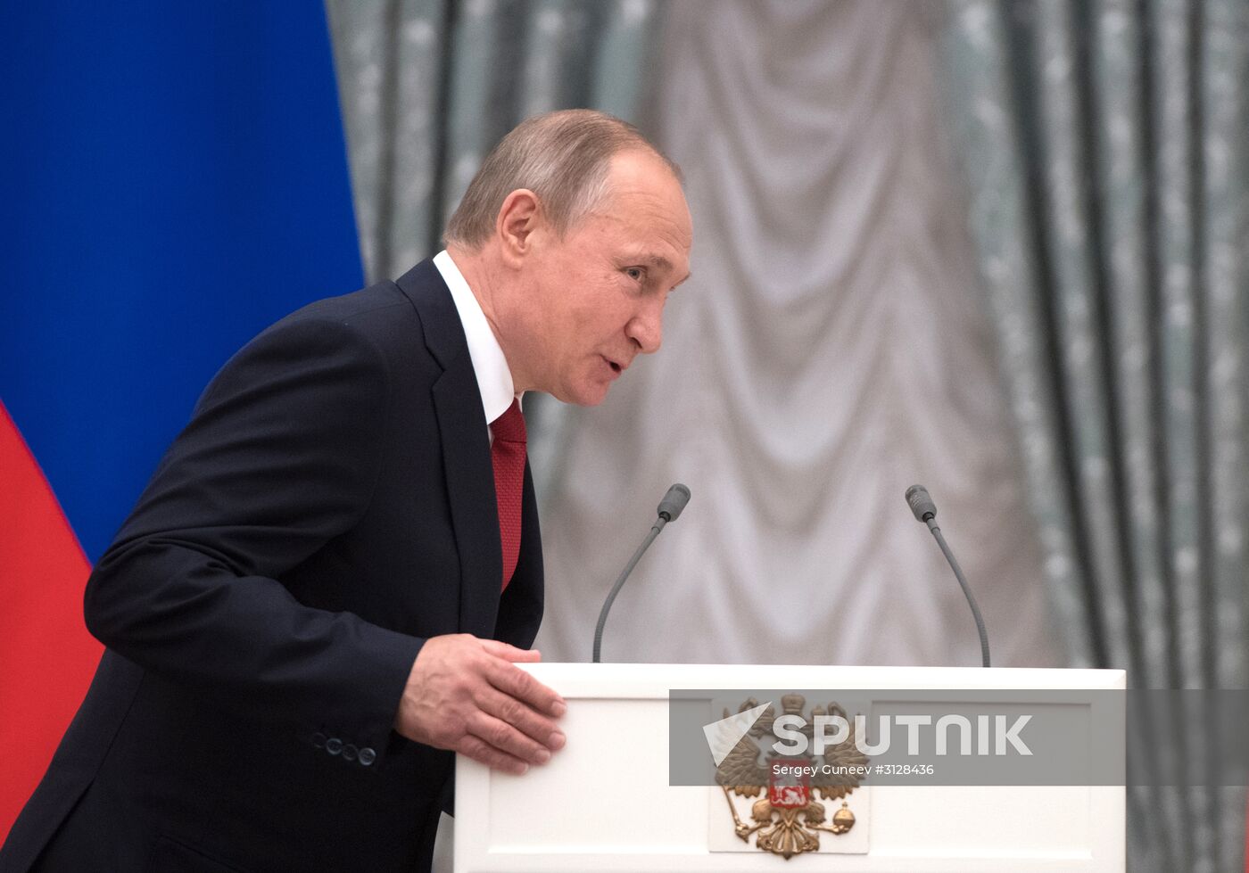 President Vladimir Putin presents passports to young Russians on Russia Day