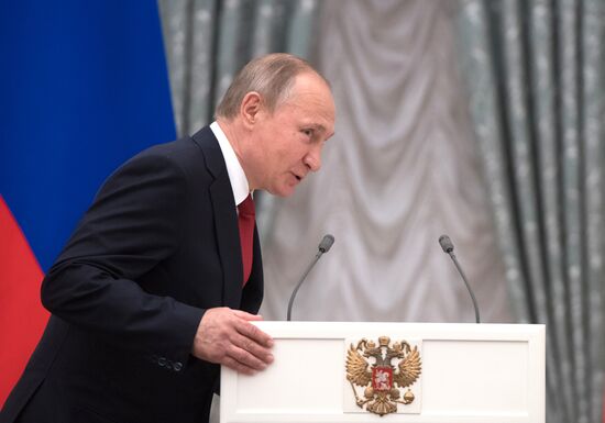 President Vladimir Putin presents passports to young Russians on Russia Day