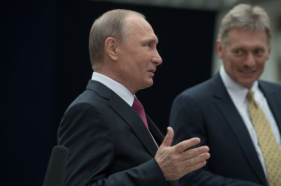 Russian President Vladimir Putin answers journalists' questions