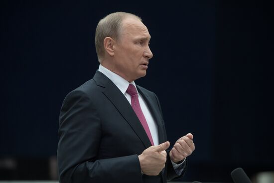 Russian President Vladimir Putin answers journalists' questions