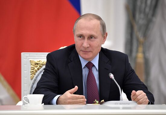 Russian President Vladimir Putin meets with graduating class teachers