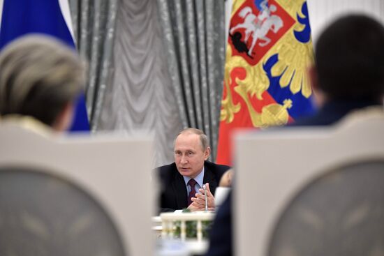 Russian President Vladimir Putin meets with graduating class teachers