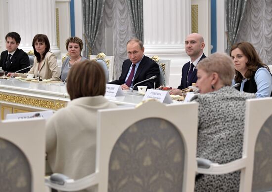 Russian President Vladimir Putin meets with graduating class teachers