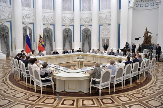 Russian President Vladimir Putin meets with graduating class teachers