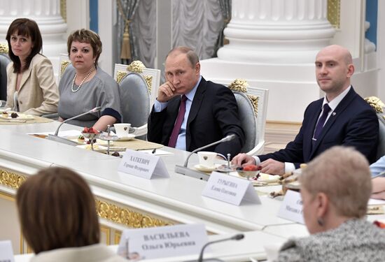 Russian President Vladimir Putin meets with graduating class teachers