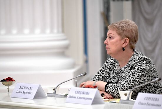 Russian President Vladimir Putin meets with graduating class teachers