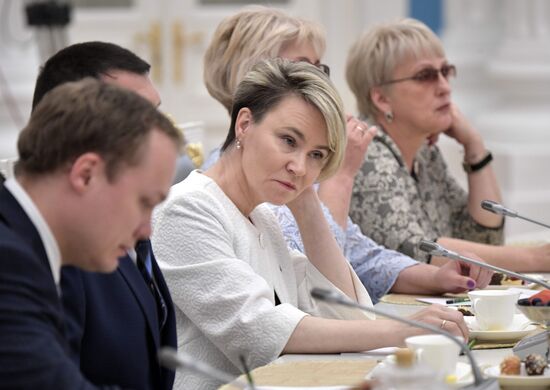 Russian President Vladimir Putin meets with graduating class teachers