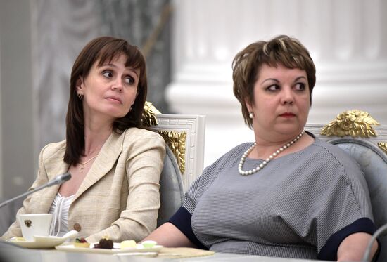 Russian President Vladimir Putin meets with graduating class teachers