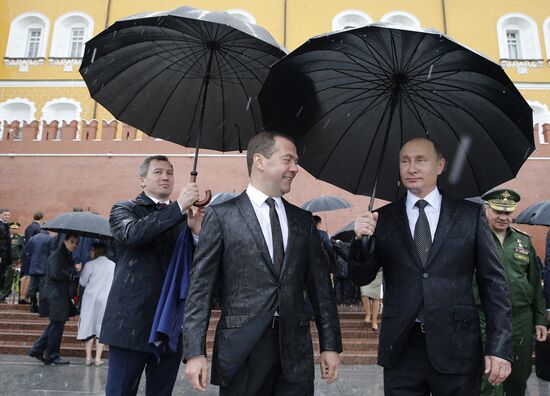 Russian President Vladimir Putin and Prime Minister Dmitry Medvedev lay flowers at Tomb of the Unknown Soldier