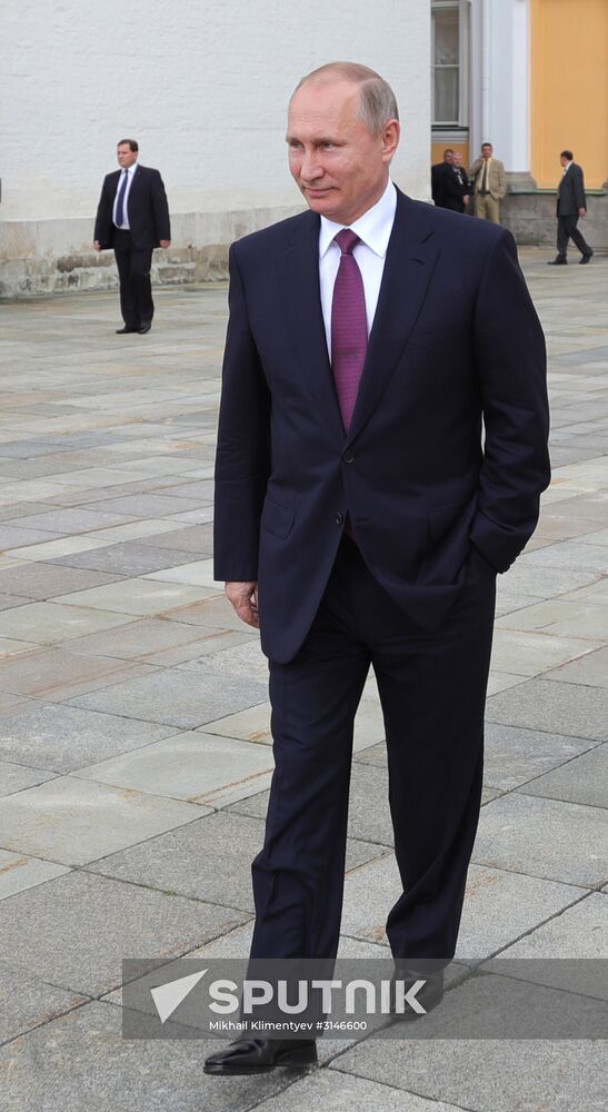 Russian President Vladimir Putin walks around the Moscow Kremlin