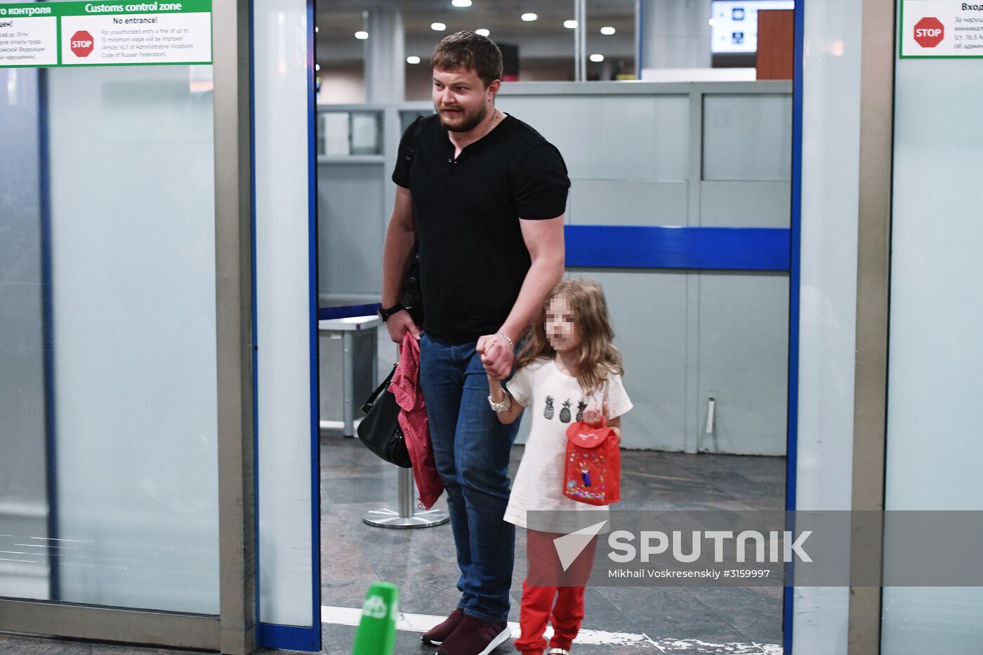 Sergei Ukhanov and his daughter Liza arrive in Moscow