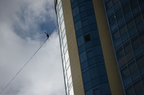 Tightrope walker Maxim Kagin walks between two skyscrapers in Yekaterinburg