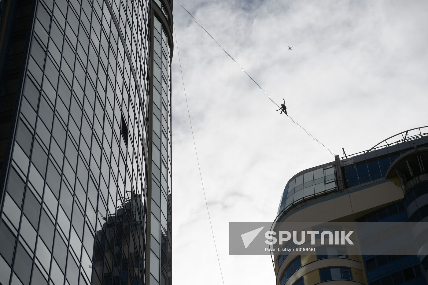 Tightrope walker Maxim Kagin walks between two skyscrapers in Yekaterinburg
