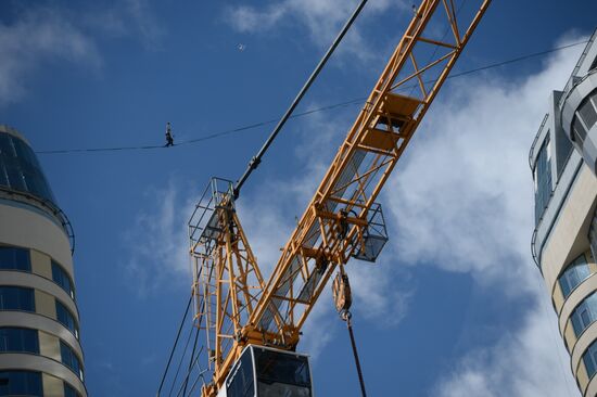 Tightrope walker Maxim Kagin walks between two skyscrapers in Yekaterinburg