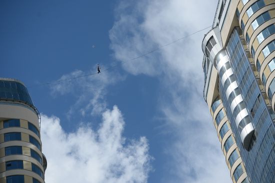 Tightrope walker Maxim Kagin walks between two skyscrapers in Yekaterinburg