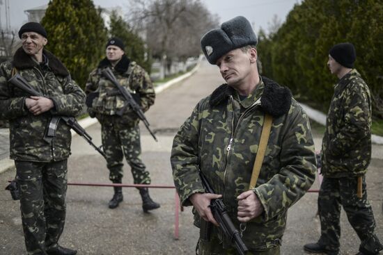 Ukrainian military men negotiate with representatives of Sevastopol self-defense units at Belbek Airbase
