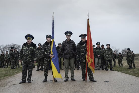 Ukrainian military men negotiate with representatives of Sevastopol self-defense units at Belbek Airbase