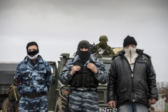 Ukrainian military men negotiate with representatives of Sevastopol self-defense units at Belbek Airbase