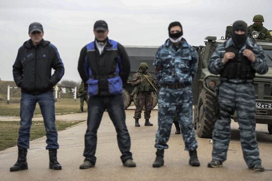 Ukrainian military men negotiate with representatives of Sevastopol self-defense units at Belbek Airbase