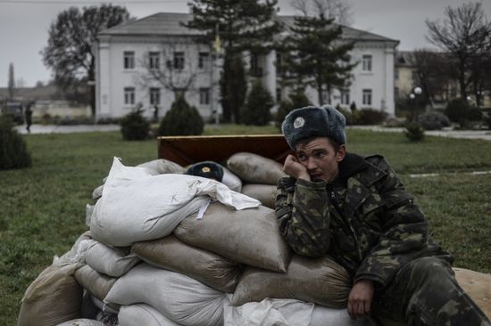 Ukrainian military men negotiate with representatives of Sevastopol self-defense units at Belbek Airbase