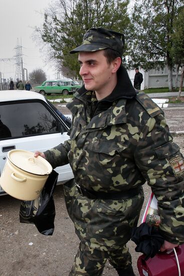 Ukrainian servicemen leave their military unit