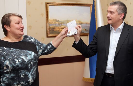 Crimean Prime Minister Sergei Aksyonov gets a Russian passport